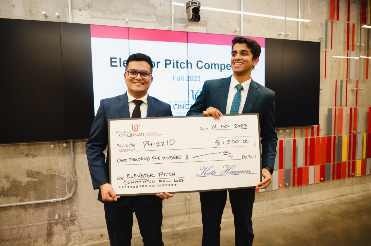 Students hold big check