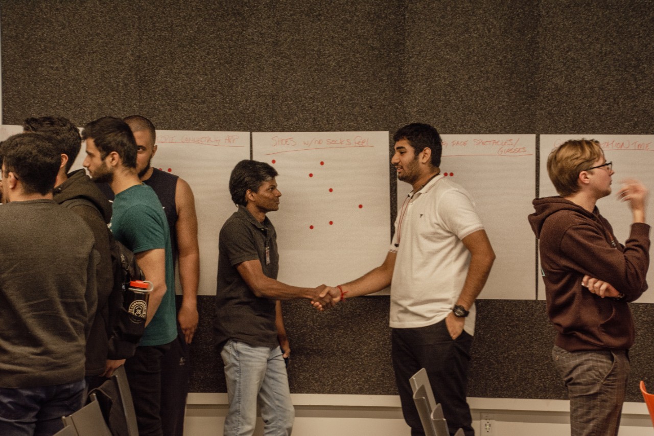 Students shake hands at startup weekend