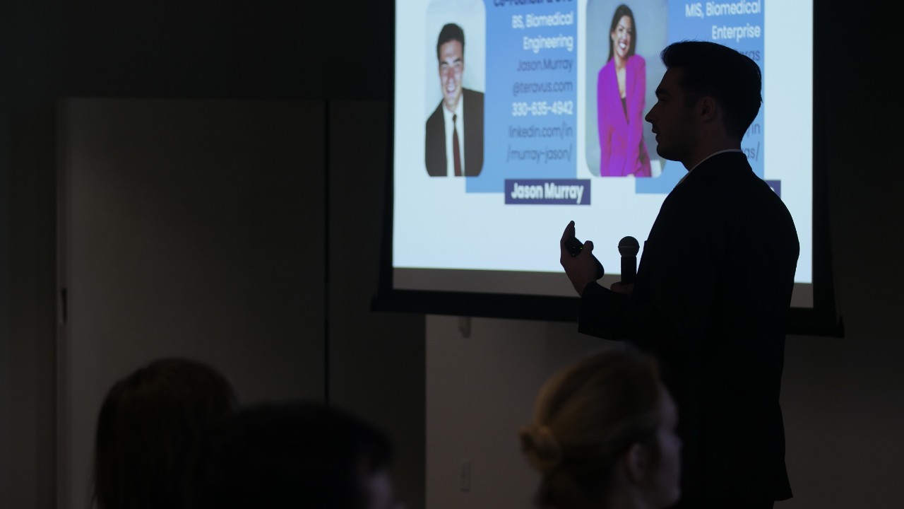 Two students shake hands at startup weekend