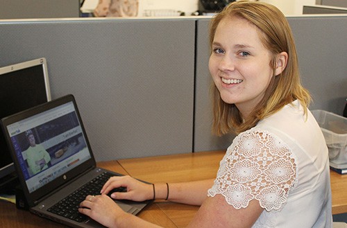 Lindner student and Enerfab co-op Sarah Becker sits at a desk with Enerfab's website open on her laptop