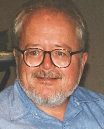 John Powers in glasses in a blue shirt.