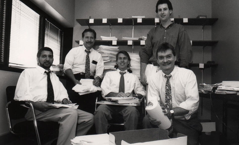 Black and white photo of Professors Amit Raturi, Jim Evans, Jeff Camm and Dave Rogers. PhD student Scott Welz stands behind them.