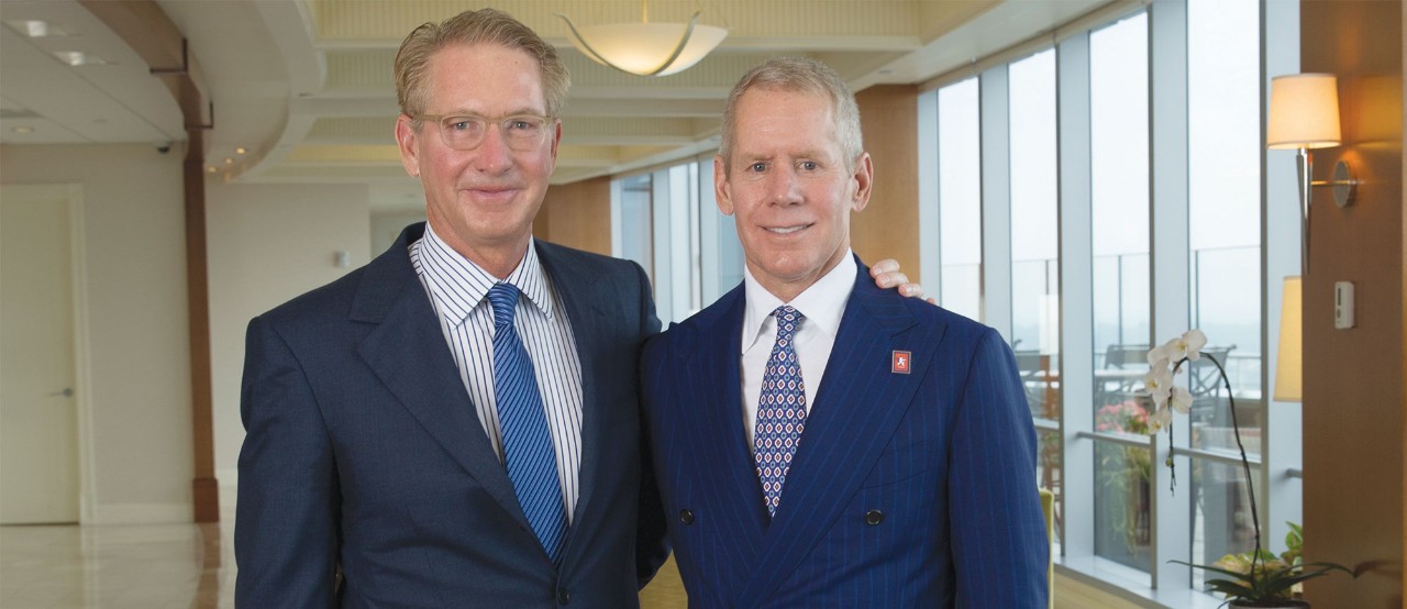 Craig Lindner, left, stands with arm around brother Carl H. Lindner III, right