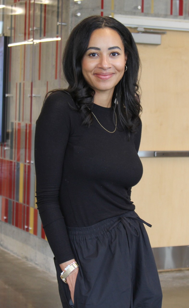 Janelle Wichmann stands in all black.