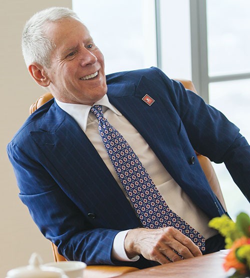 Carl Lindner III, seated at a conference table