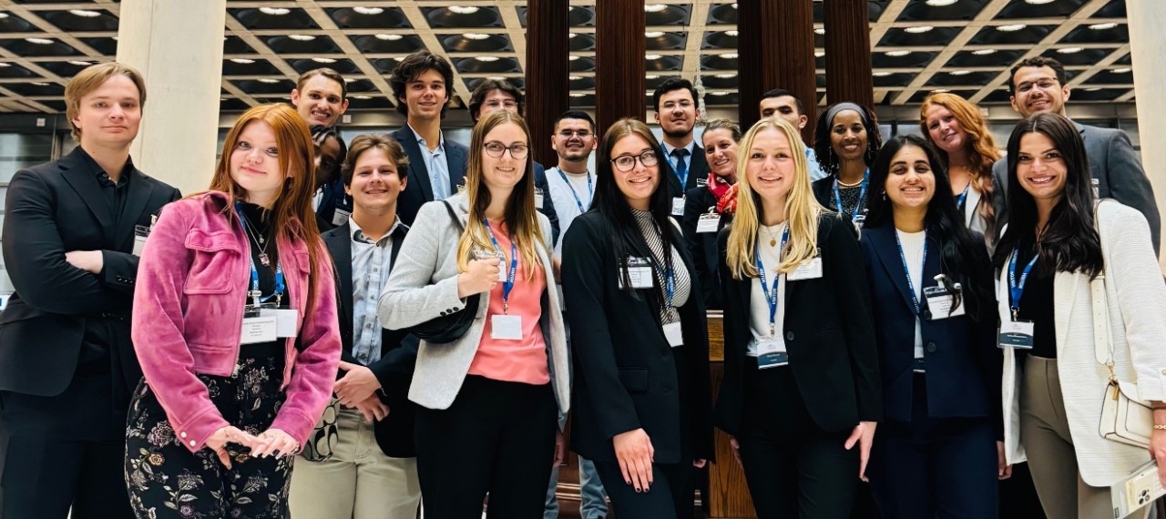 A group of students at Lloyd's London smile.