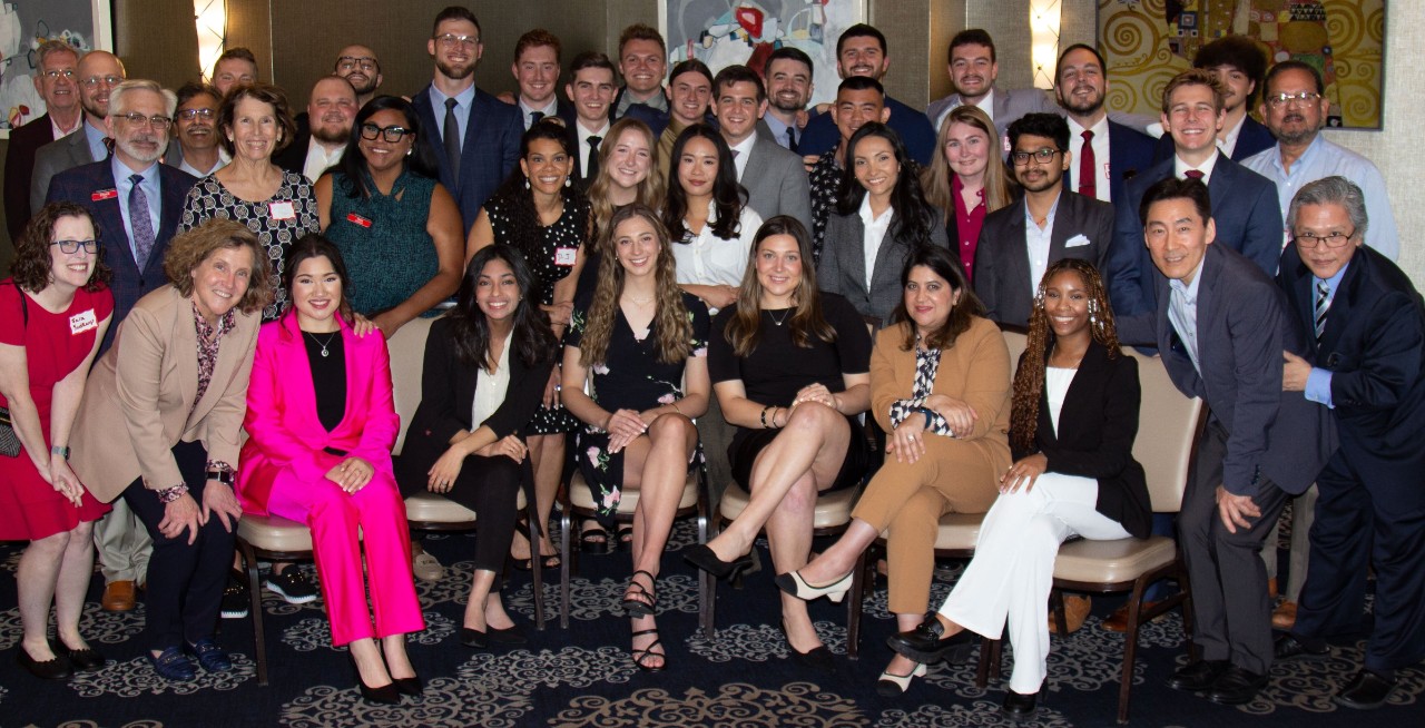 A large group of MBA graduates and Lindner MBA stakeholders pose for a group picture.