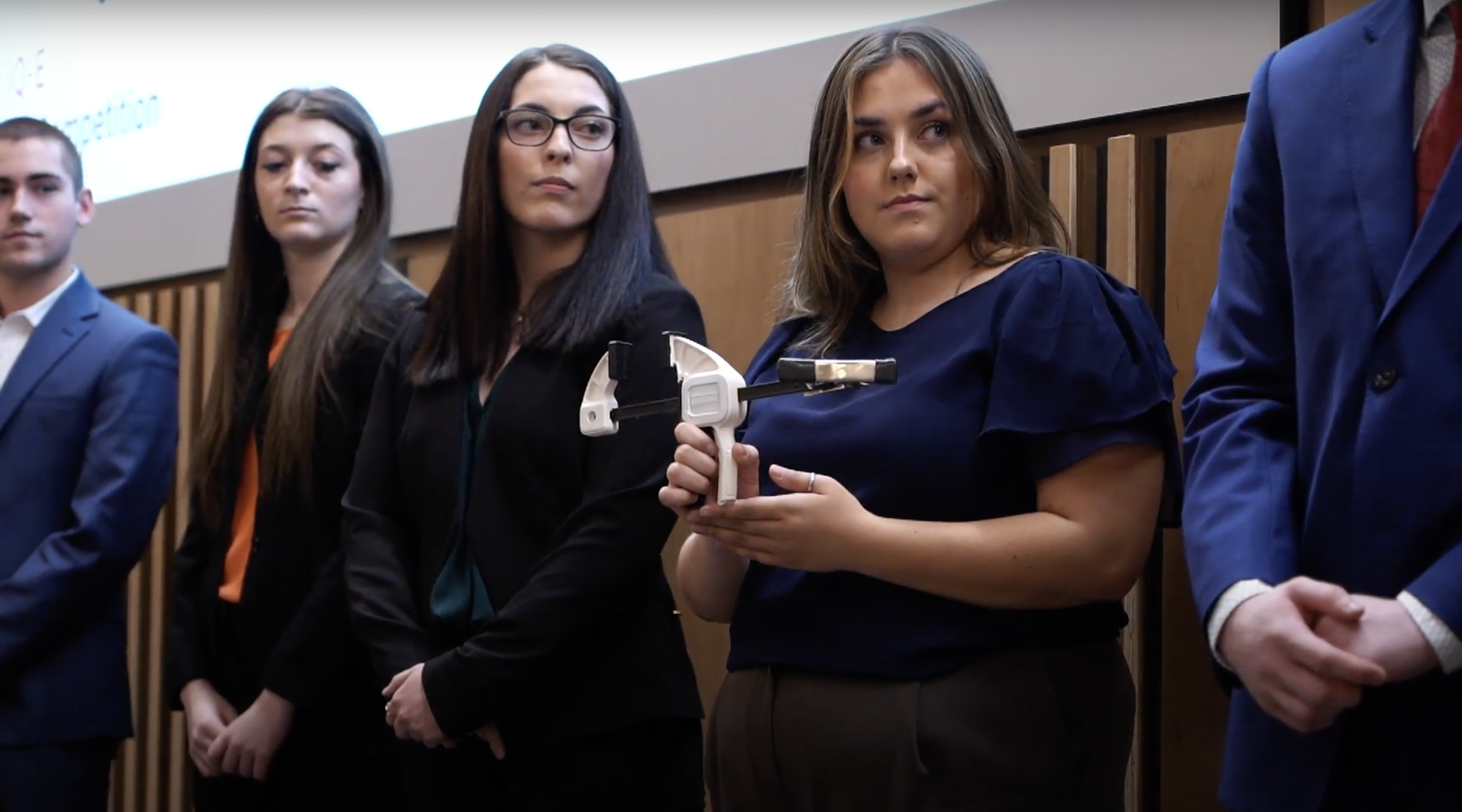 Student holds prototype at first year fast pitch competition